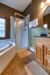Master bath with a jetted tub and stand up shower